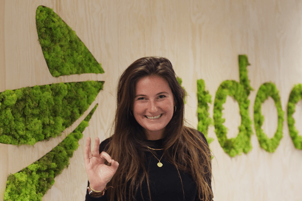An happy Rydooer! An happy Rydooer smiling in front of the Rydoo logo made with grass