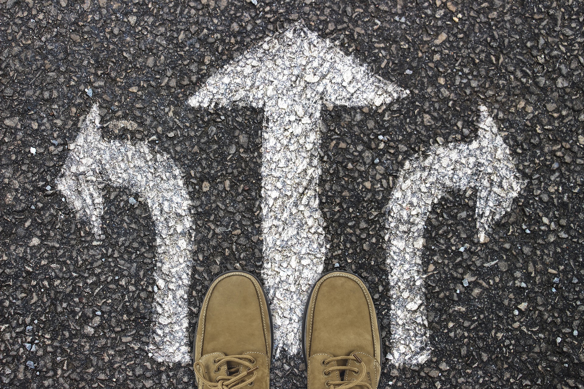 Arrows on the road illustrating difficult decision