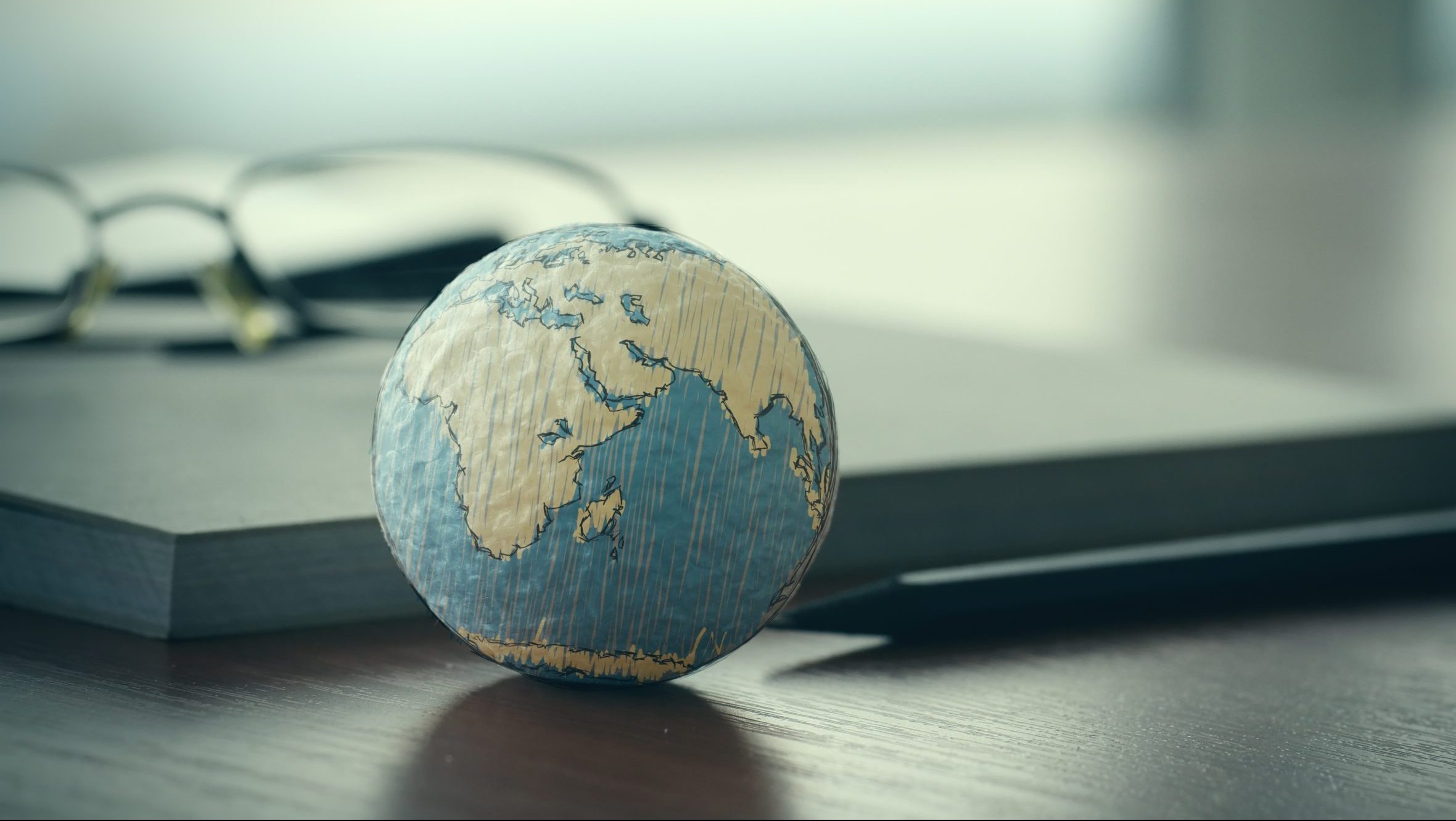 Globe on a desk, illustrating why you need to think globally when starting a business.